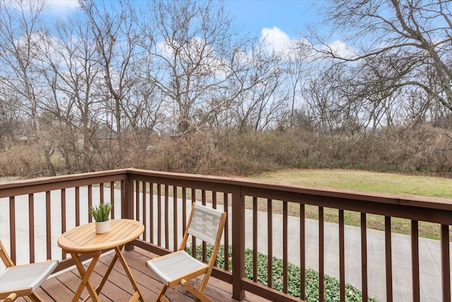 wooden terrace with a lawn