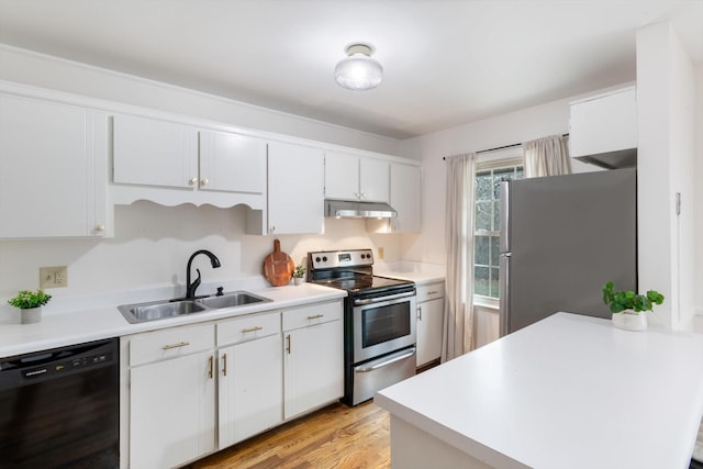 kitchen featuring appliances with stainless steel finishes, sink, light hardwood / wood-style flooring, and white cabinets