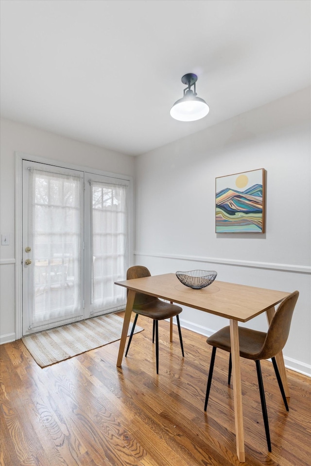 dining space featuring wood-type flooring