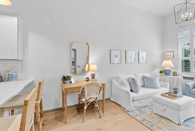 living room featuring an inviting chandelier and light hardwood / wood-style flooring