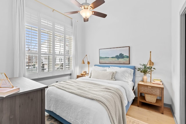 bedroom featuring light hardwood / wood-style floors and ceiling fan