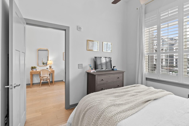 bedroom with ceiling fan and light wood-type flooring