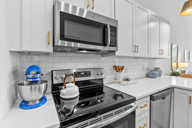 kitchen with white cabinetry, stainless steel appliances, and decorative backsplash