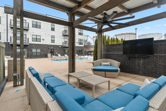 view of patio featuring an outdoor living space, a community pool, and ceiling fan