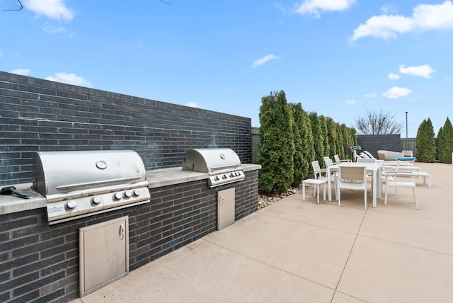 view of patio / terrace featuring area for grilling and a grill