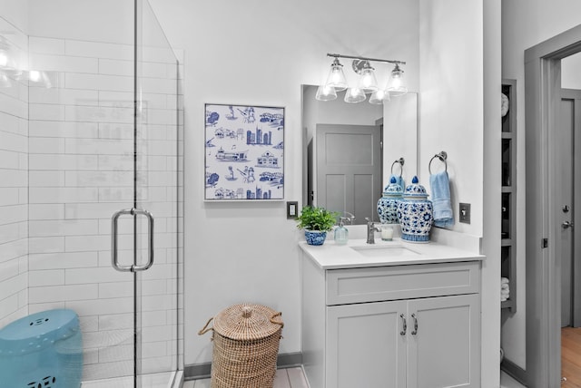 bathroom with vanity and a shower with shower door