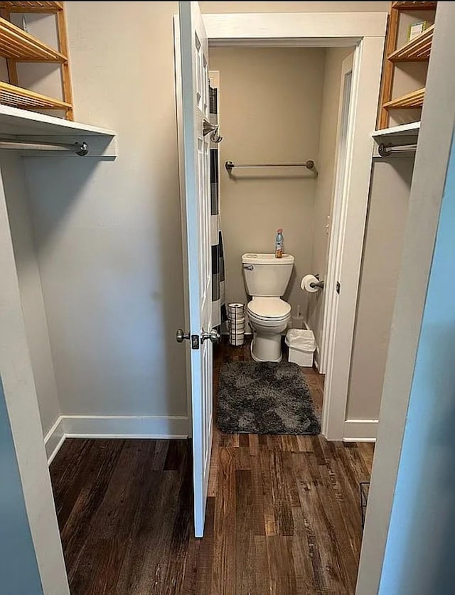 bathroom with hardwood / wood-style flooring and toilet