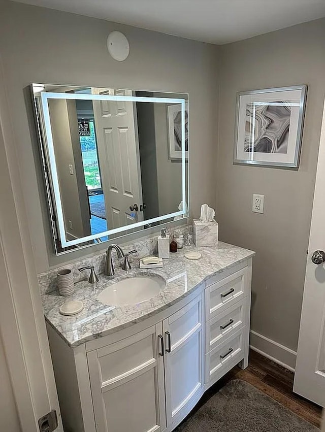 bathroom featuring vanity and hardwood / wood-style floors