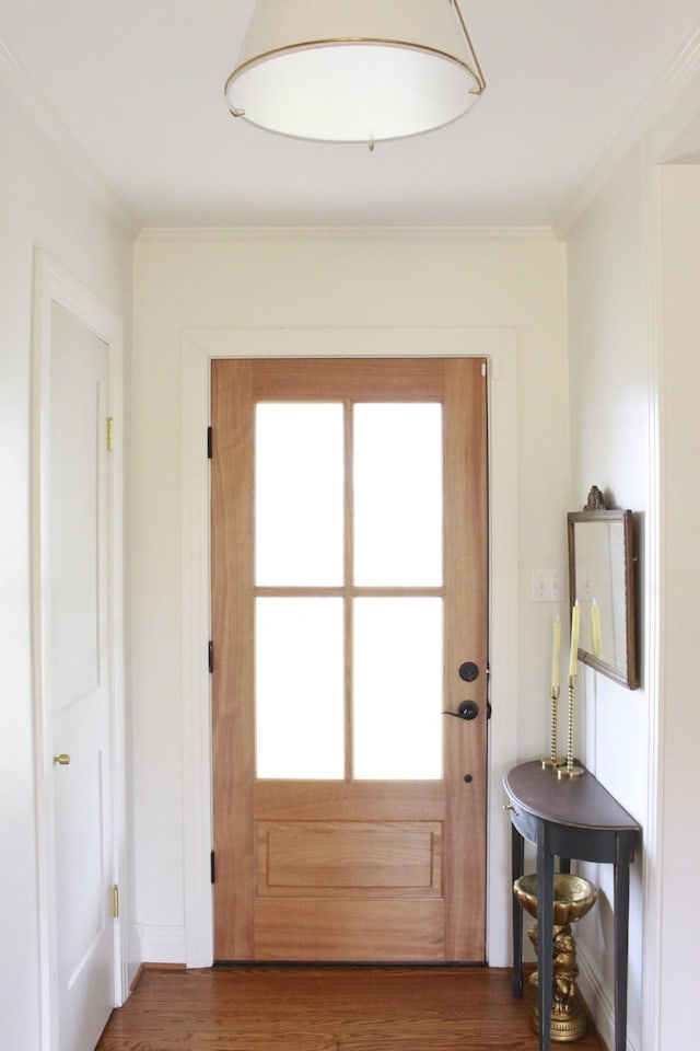 entryway with crown molding, plenty of natural light, and dark hardwood / wood-style flooring