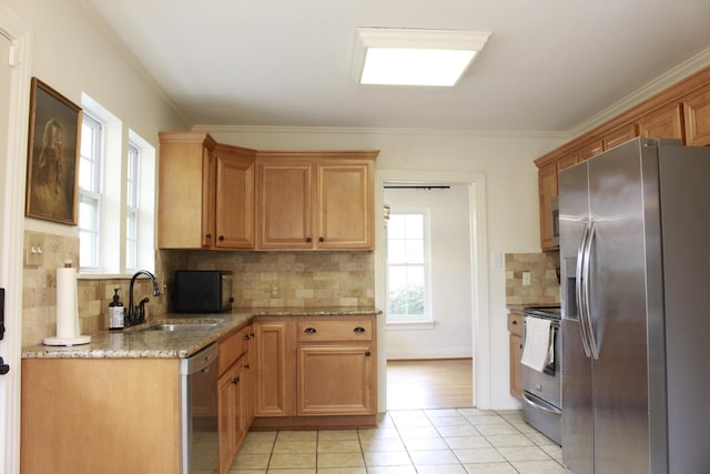 kitchen featuring sink, light tile patterned floors, plenty of natural light, and stainless steel appliances