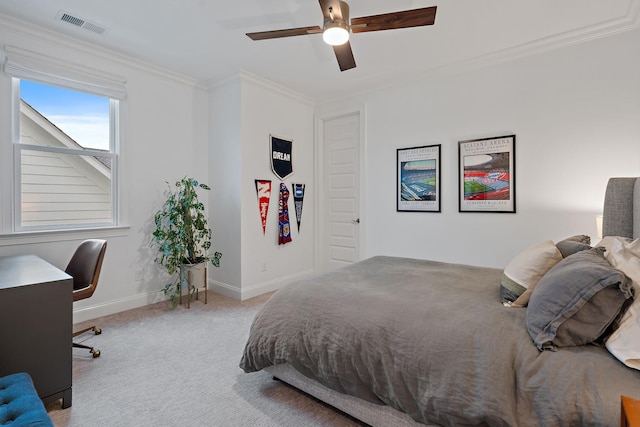 carpeted bedroom featuring ornamental molding and ceiling fan