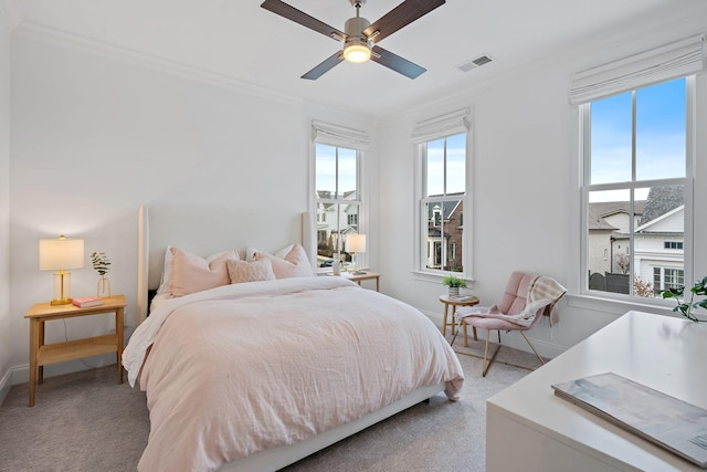 carpeted bedroom with crown molding and ceiling fan