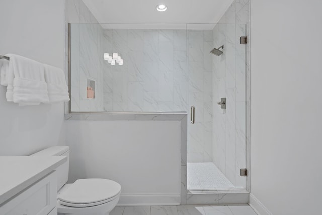 bathroom featuring vanity, toilet, and an enclosed shower