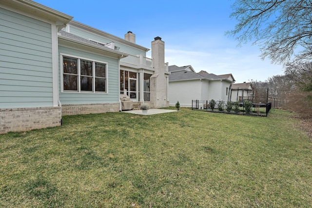 back of house featuring a patio and a yard