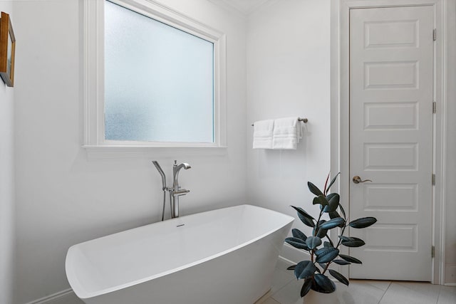 bathroom with tile patterned floors and a tub to relax in