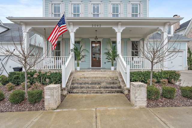 view of front facade with a garage and covered porch