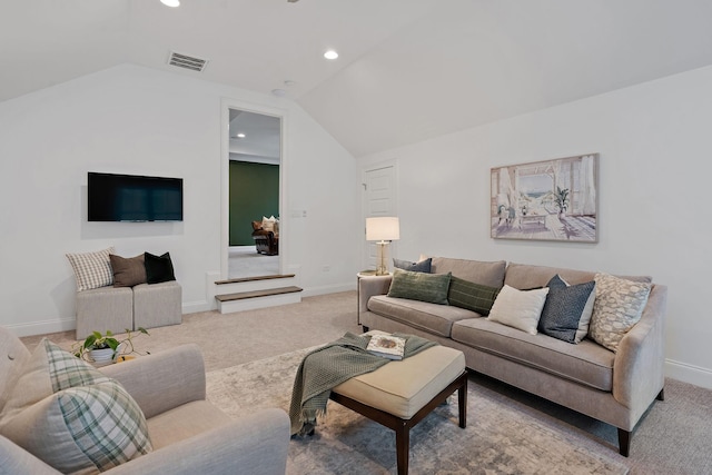 carpeted living room with vaulted ceiling