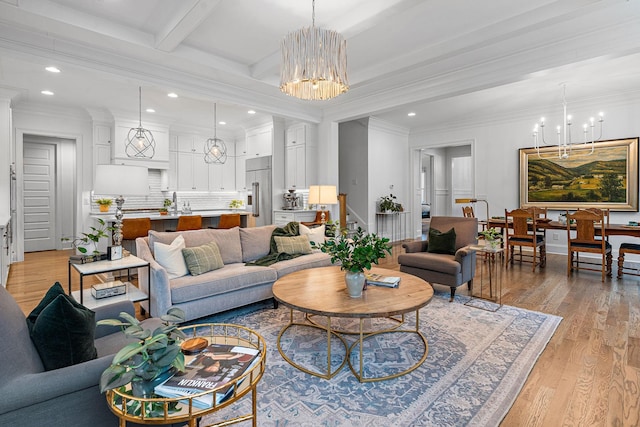 living room featuring ornamental molding, beam ceiling, light hardwood / wood-style flooring, and a notable chandelier