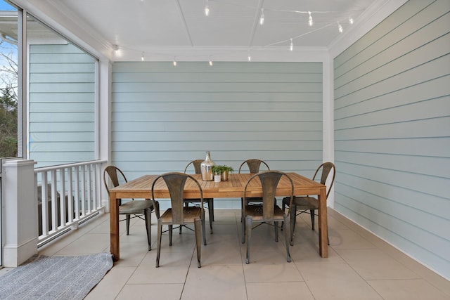 dining space with light tile patterned floors and track lighting