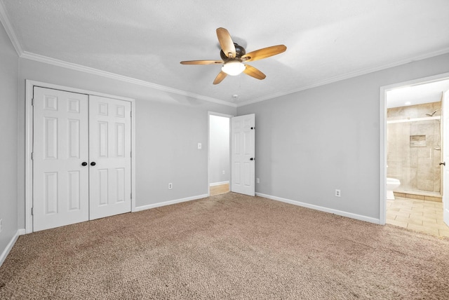 unfurnished bedroom with connected bathroom, carpet floors, ornamental molding, and a closet