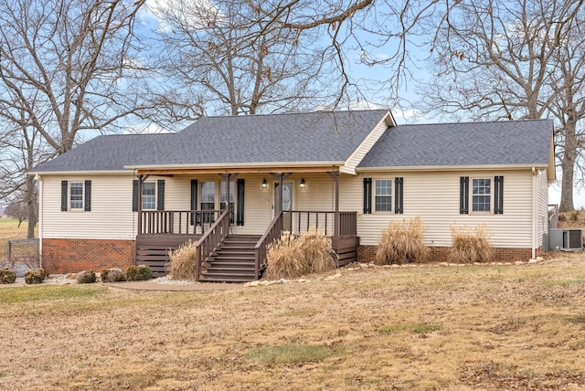 ranch-style home with central AC, a front lawn, and a porch