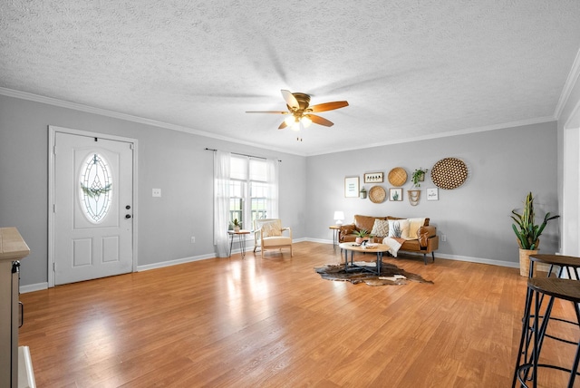 entrance foyer with crown molding, a textured ceiling, ceiling fan, and light hardwood / wood-style floors