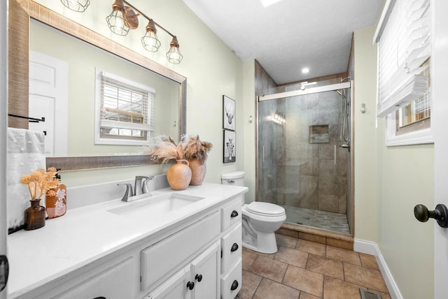 bathroom featuring toilet, vanity, a textured ceiling, and a shower with shower door