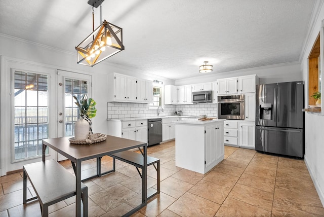 kitchen with white cabinetry, stainless steel appliances, a center island, decorative backsplash, and decorative light fixtures