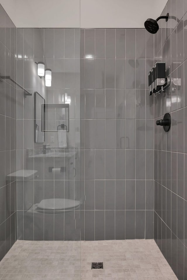 bathroom with a tile shower