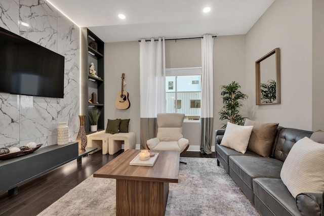 living room featuring light hardwood / wood-style flooring and built in features