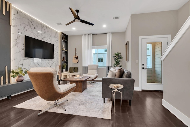 living room with dark hardwood / wood-style floors and ceiling fan