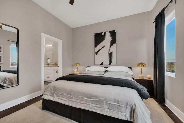 bedroom with ceiling fan, dark hardwood / wood-style flooring, and ensuite bath