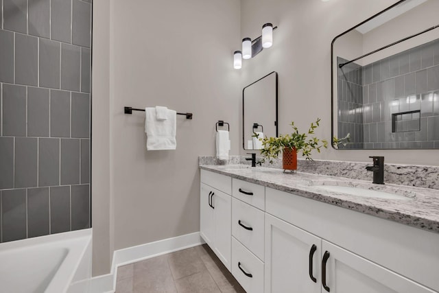 bathroom with tile patterned floors, vanity, and tiled shower / bath