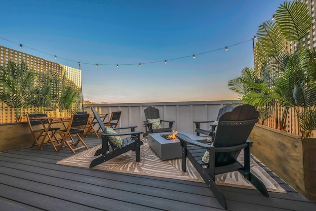 deck at dusk with a fire pit