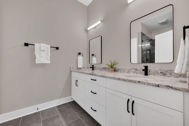 bathroom featuring vanity, a shower with door, and tile patterned flooring