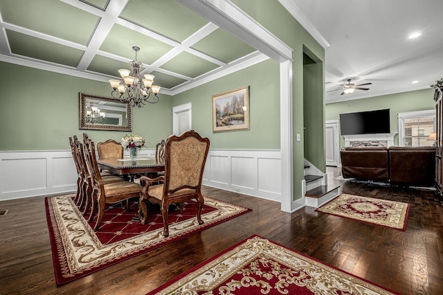 dining space featuring dark hardwood / wood-style flooring, ceiling fan with notable chandelier, ornamental molding, and coffered ceiling