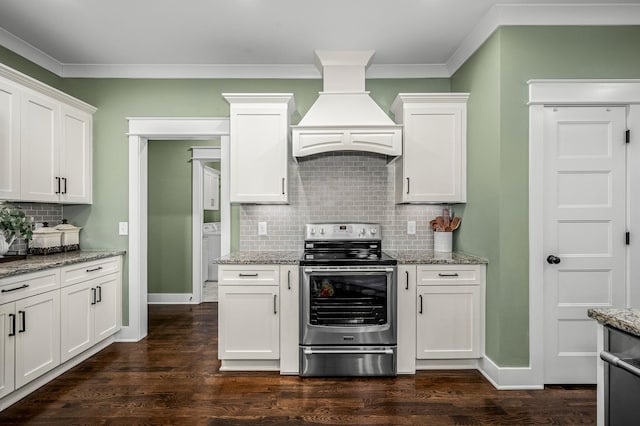 kitchen featuring light stone counters, custom range hood, stainless steel electric range, and white cabinets