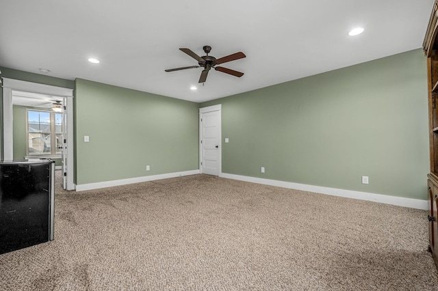 unfurnished room featuring ceiling fan and carpet