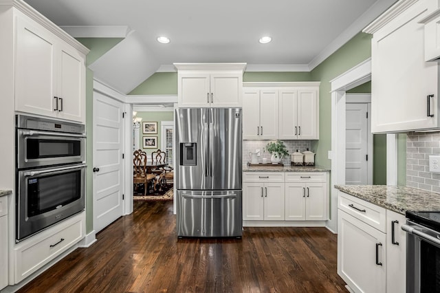 kitchen featuring white cabinetry, backsplash, dark hardwood / wood-style flooring, light stone counters, and stainless steel appliances