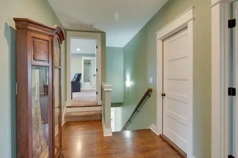 corridor with hardwood / wood-style floors