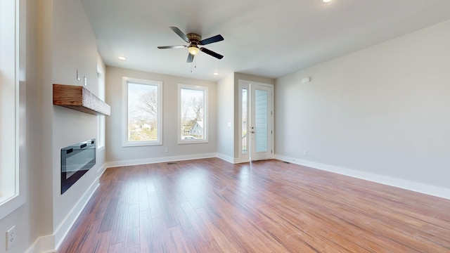 unfurnished living room featuring light hardwood / wood-style floors and ceiling fan