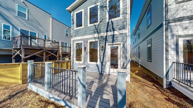 rear view of property featuring a wooden deck