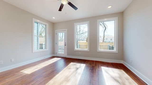 empty room featuring dark hardwood / wood-style floors and ceiling fan