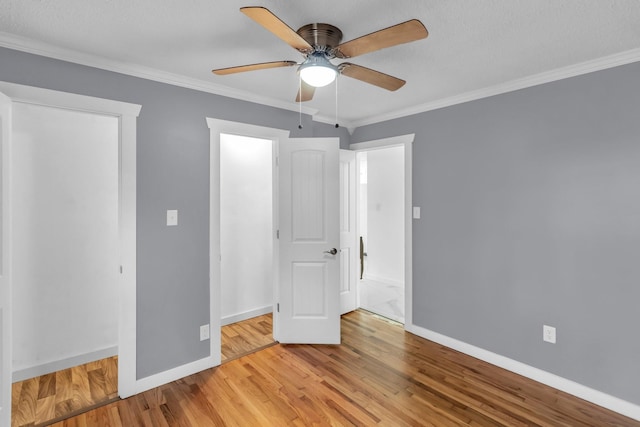 unfurnished bedroom featuring ornamental molding, ceiling fan, and light wood-type flooring