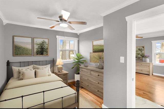 bedroom with crown molding, ceiling fan, and light hardwood / wood-style flooring