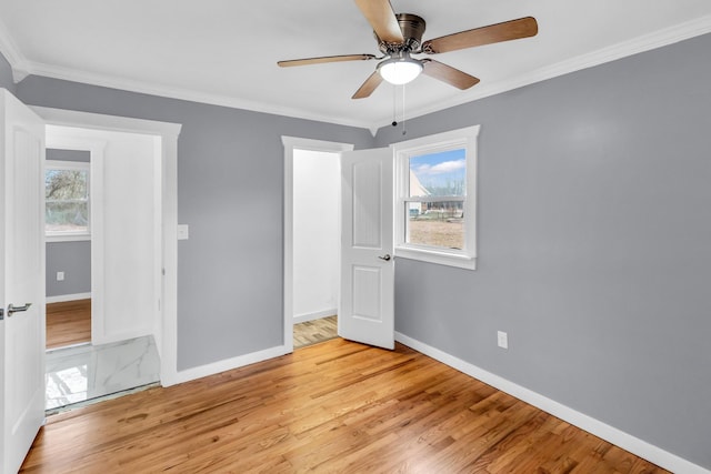 unfurnished bedroom with ceiling fan, ornamental molding, and light hardwood / wood-style floors