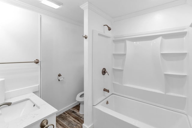 full bathroom with toilet, bathing tub / shower combination, wood-type flooring, ornamental molding, and vanity