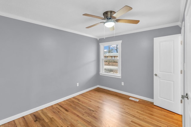 empty room featuring crown molding, ceiling fan, and light wood-type flooring