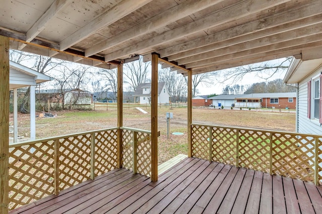 wooden terrace featuring a yard