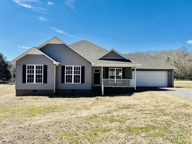 view of front of house featuring a garage, covered porch, and a front lawn